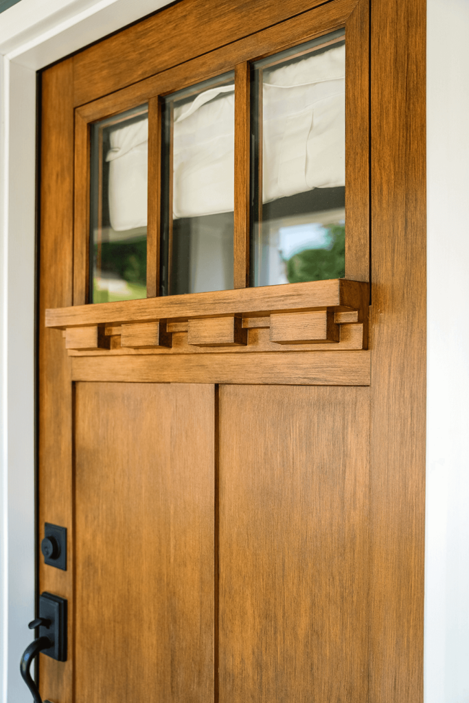 A close up photo of the Signet Fir shelf entry door in almond